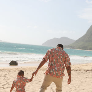 little boy wearing jade colored aloha button up with tiare ginger print