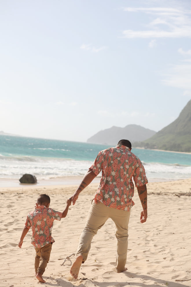 little boy wearing jade colored aloha button up with tiare ginger print