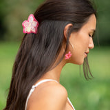 woman wearing a small pink and peach orchid hairclip in hair 