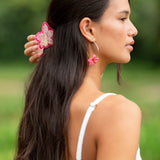 woman wearing a small pink and peach orchid hairclip in hair 