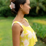 woman wearing a large peach and white orchid hair clip in hair