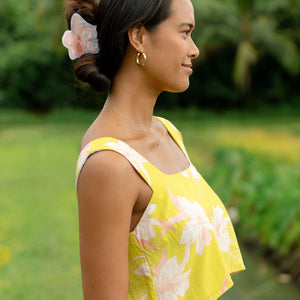 woman wearing a large peach and white orchid hair clip in hair