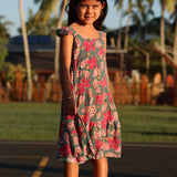 little girl wearing a teal dress with flutter sleeves with shell and pua print