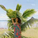 woman wearing rich teal pareo with red hau flower print