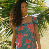 woman wearing rich teal pareo with red hau flower print