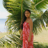 woman with brown hair wearing red pareo with pink hau flower print