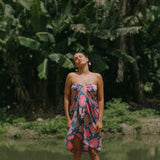 woman with brown hair wearing blue and pink pareo with hibiscus print