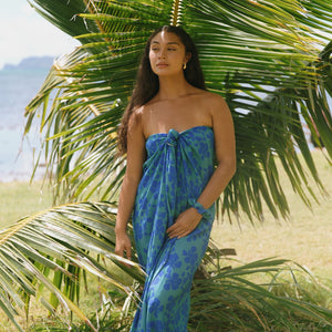 woman with brown hair wearing teal aqua pareo with blue solid hibiscus print