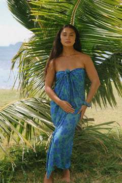 woman with brown hair wearing teal aqua pareo with blue solid hibiscus print