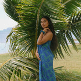 woman with brown hair wearing teal aqua pareo with blue solid hibiscus print
