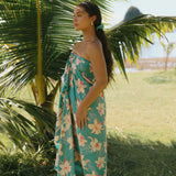 woman with brown hair wearing teal pareo with orchid print