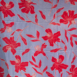 a pareo with periwinkle background and bright red hibiscus print.