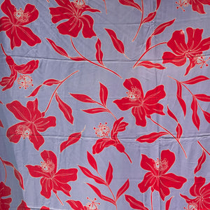 a pareo with periwinkle background and bright red hibiscus print.