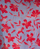 a pareo with periwinkle background and bright red hibiscus print.