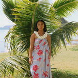 woman with brown hair wearing light lavender hibiscus pareo