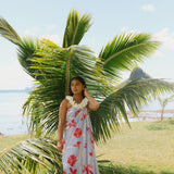 woman with brown hair wearing light lavender hibiscus pareo