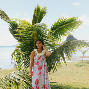 woman with brown hair wearing light lavender hibiscus pareo
