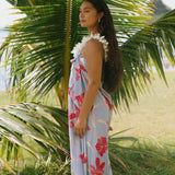 woman with brown hair wearing light lavender hibiscus pareo