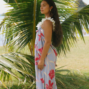 woman with brown hair wearing light lavender hibiscus pareo
