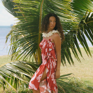 woman with brown hair wearing red pareo with light pink ginger + lei print
