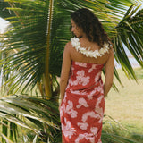 woman with brown hair wearing red pareo with light pink ginger + lei print