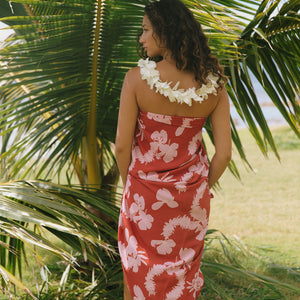 woman with brown hair wearing red pareo with light pink ginger + lei print