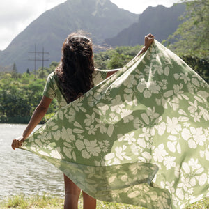 woman wearing a green pareo with native Hawaii plants 