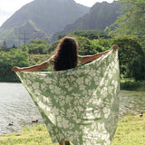 woman wearing a green pareo with native Hawaii plants 