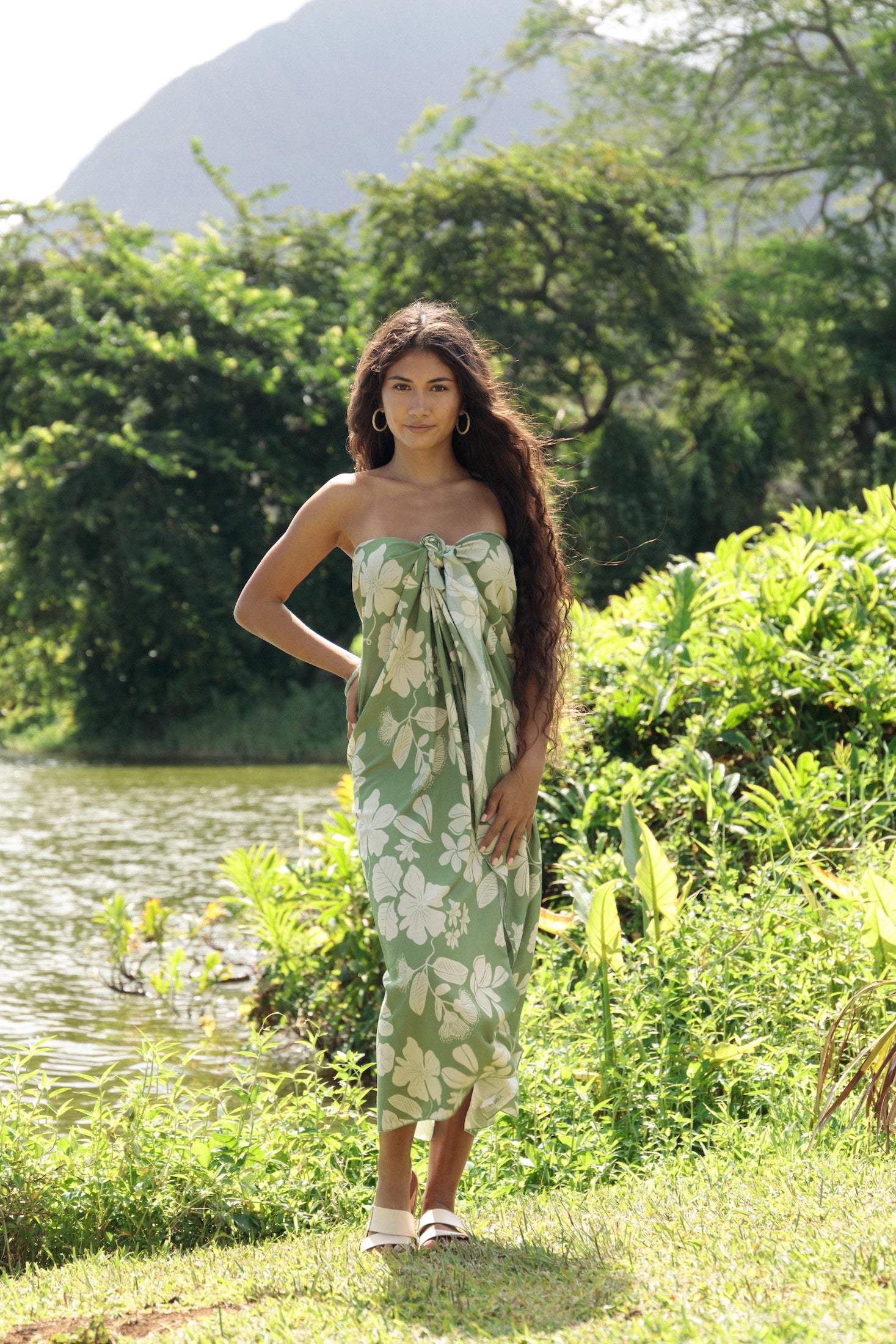 woman wearing a green pareo with native Hawaii plants 