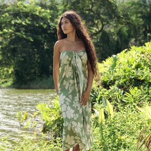 woman wearing a green pareo with native Hawaii plants 