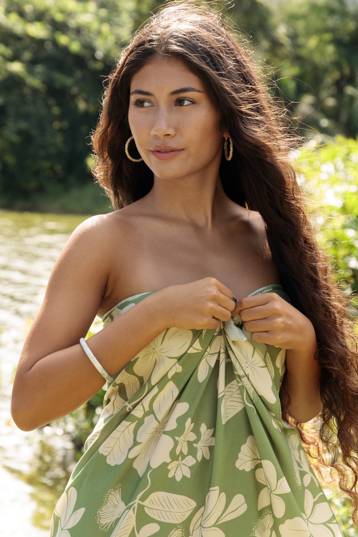 woman wearing a green pareo with native Hawaii plants 