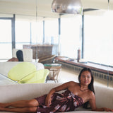 woman wearing brown pareo with protea pattern
