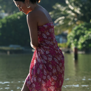 woman wearing a pareo wrap with shella and pua print in pink