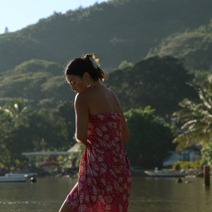 woman wearing a pareo wrap with shella and pua print in pink