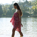 woman wearing a pareo wrap with shella and pua print in pink