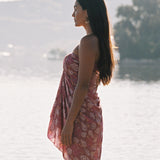 woman wearing a pareo wrap with shella and pua print in pink