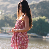 woman wearing a pareo wrap with shella and pua print in pink