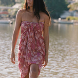 woman wearing a pareo wrap with shella and pua print in pink