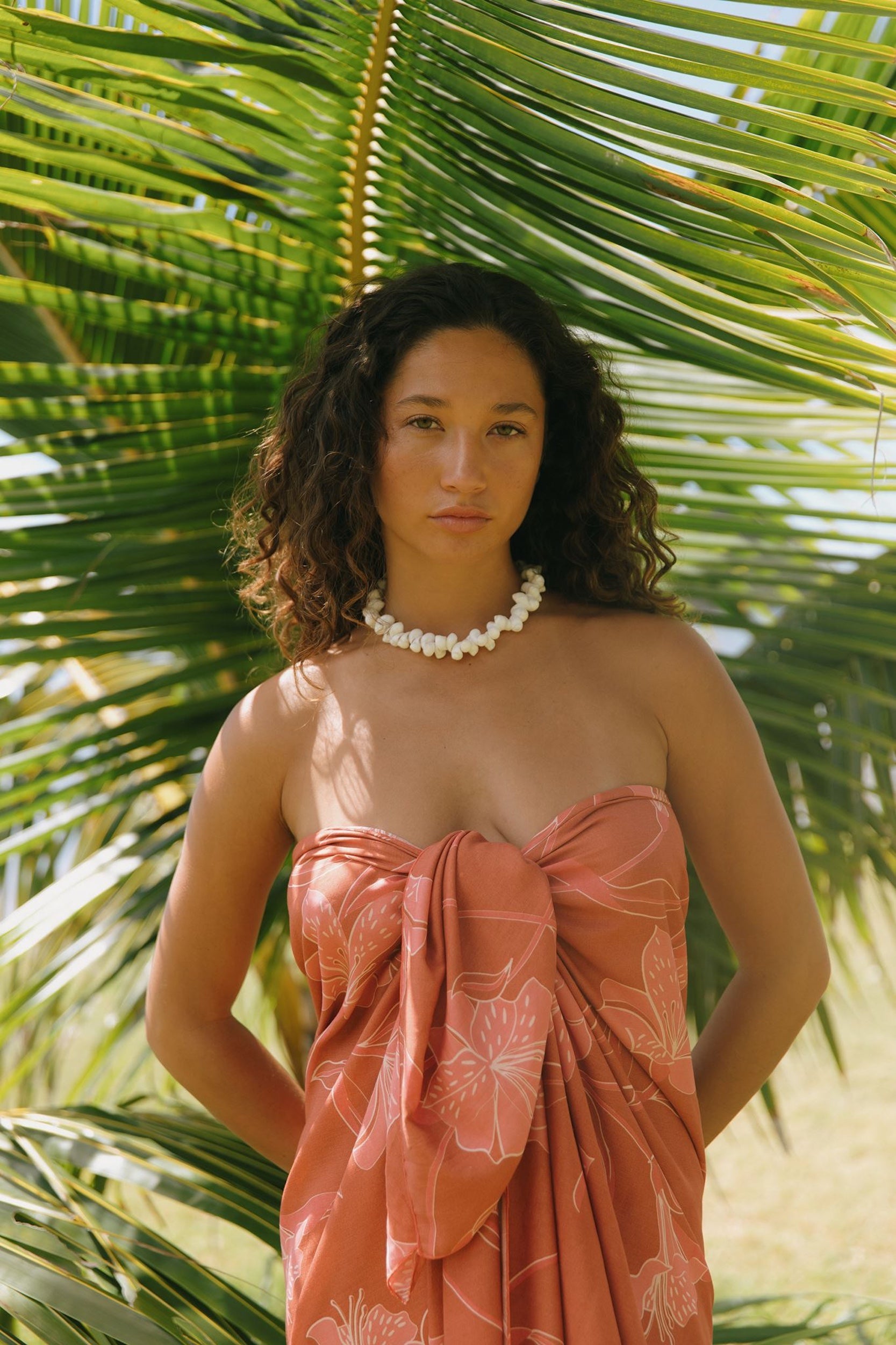 woman with brown hair wearing terra colored pareo