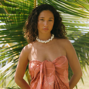 woman with brown hair wearing terra colored pareo