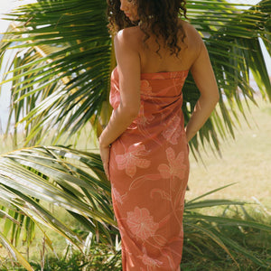 woman with brown hair wearing terra colored pareo