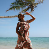 woman with brown hair wearing jade colored pareo with tiare ginger print