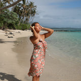 woman with brown hair wearing jade colored pareo with tiare ginger print