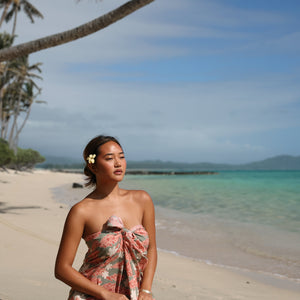 woman with brown hair wearing jade colored pareo with tiare ginger print