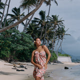 woman with brown hair wearing jade colored pareo with tiare ginger print