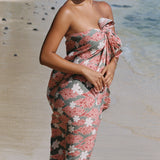 woman with brown hair wearing jade colored pareo with tiare ginger print