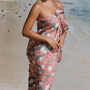 woman with brown hair wearing jade colored pareo with tiare ginger print