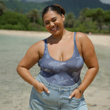 woman wearing a bodysuit with blue hibiscus pattern