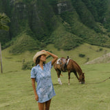 woman with brown hair wearing blue paniolo print collared button down dress