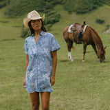 woman with brown hair wearing blue paniolo print collared button down dress
